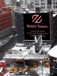 a billboard on top of a building says rokhi token enhancing creative industry with cryptocurrency