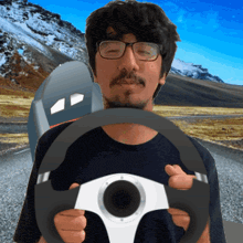 a man wearing glasses holds a steering wheel in front of a mailbox