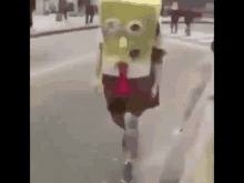 a person dressed as spongebob squarepants is running down a street .