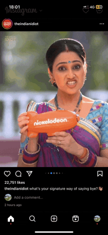 a woman is holding a nickelodeon balloon