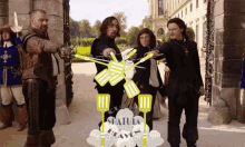 a group of men are standing in front of a sign that says spatula for good and savor for all