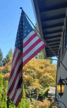 a large american flag is hanging from the side of a building