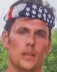 a man wearing an american flag headband on his head .