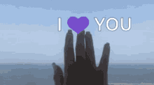 a hand making a heart shape with the words i love you