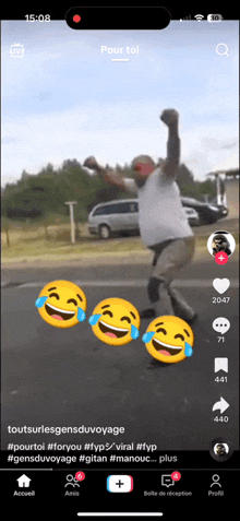 a phone screen shows a video of a man on a skateboard with laughing faces around him