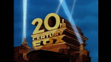 a 20th century fox logo is being projected on a building with a blue sky in the background .