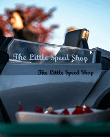 a car with a sticker on the side that says the little speed shop