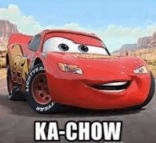 lightning mcqueen from cars is smiling while driving down a road .