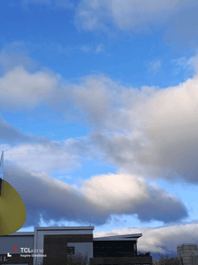 a tcl cell phone shows a cloudy sky