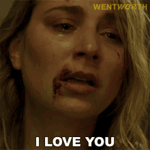 a close up of a woman 's face with blood on it and the words " i love you "