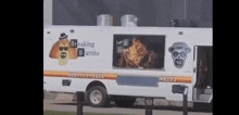 a breaking bad burrito food truck is parked in front of a building