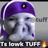 a baby wearing a purple headband with the words ts lowk tuff on the bottom
