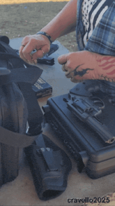 a man holds a gun next to a case that says ' cratello 2025 ' on it