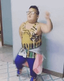 a young boy wearing glasses and a leopard print tank top is sitting on a chair .