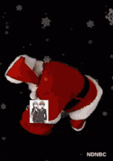 a picture of a man and a woman standing next to santa