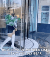 a woman is walking through a glass door with the words boujee wouldve been like heyy cuddly bear on the bottom