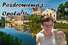 a woman and a boy are posing for a picture in front of a river with the words pozdrowienia z opola !!!