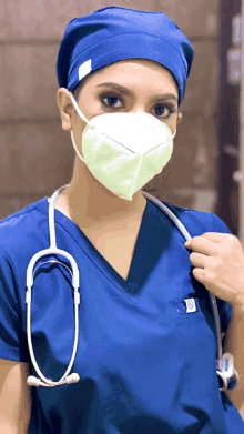 a nurse wearing a mask and a blue scrub top