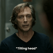 a close up of a man 's face with the words * tilting head * below him
