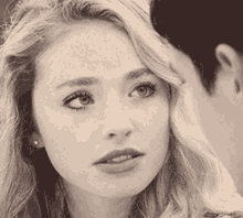a close up of a woman looking at a man