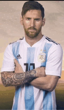 a man with a beard is wearing a blue and white adidas jersey