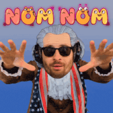 a man wearing sunglasses and headphones is standing in front of a sign that says nom nom