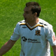 a man wearing a white jersey that says ' league ' on it