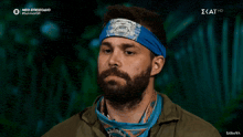 a man with a beard wearing a headband that says survivor on it