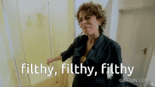 a woman says filthy filthy filthy in front of a yellow wall