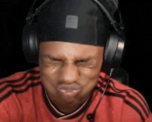 a man wearing headphones making a funny face