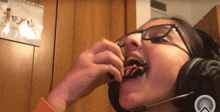 a girl wearing glasses and headphones eating a snack