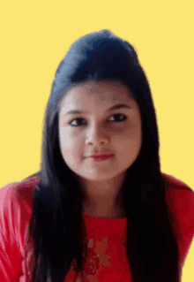 a woman wearing a red shirt with a flower on it