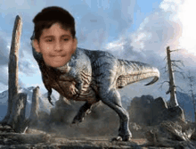 a boy is standing in front of a t-rex with his face on its back .