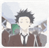 a young man in a suit and tie is walking down a street .