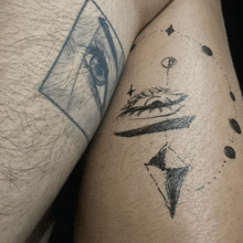 a close up of a tattoo on a person 's leg with a drawing of an eye