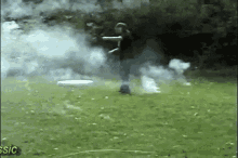 a man throws a frisbee in a field with smoke coming out of it and the words classic on the bottom