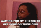 a woman wearing sunglasses is waiting for her chores to get done on their own