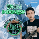 a man wearing headphones and holding a guitar in front of a poster that says crom indonesia rest area 04