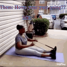 a woman sits on a yoga mat with a resistance band around her waist and the words " them hows your year going " above her