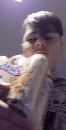 a young man holds a roll of lysol toilet paper in his hand