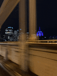 a blurry picture of a city skyline at night with a building that says chase on it