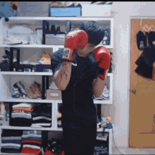 a man wearing red boxing gloves with the letter l on them