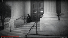 a black and white photo of a woman sitting on the steps of a building with trauma in florida written on the bottom