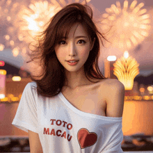 a woman wearing a toto macau t-shirt with a heart on it