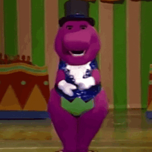 a purple dinosaur is wearing a top hat and gloves and dancing .
