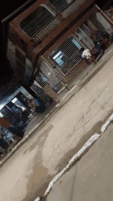 a group of people are gathered outside a building at night