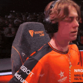 a man wearing headphones is sitting in a chair that says secret lab