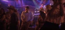 a group of cowboys are dancing in front of a band