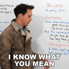 a man stands in front of a white board with the words " i know what you mean "