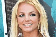 a close up of britney spears ' face with a smile on her face